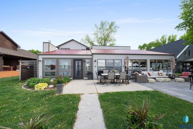 6604 Peninsula Pt, Wentworth, SD 57075 - back of property featuring a patio, a chimney, metal roof, and outdoor lounge area