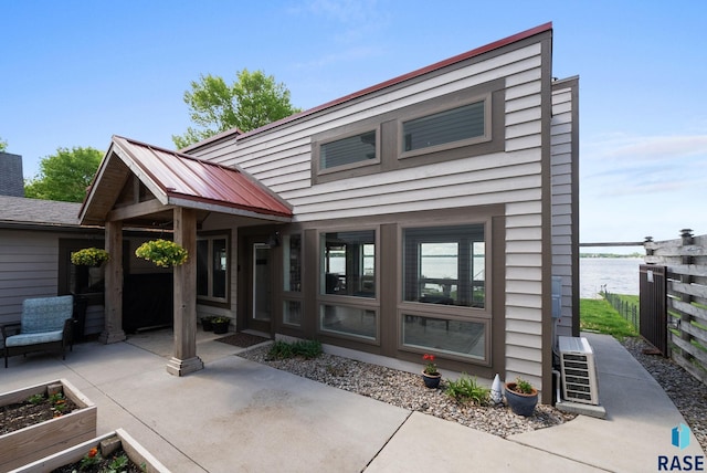 6604 Peninsula Pt, Wentworth, SD 57075 - view of front facade featuring a patio area and a water view