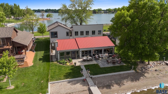 6604 Peninsula Pt, Wentworth, SD 57075 - back of house featuring a patio area, a water view, metal roof, outdoor lounge area, and a yard