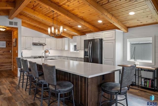 6604 Peninsula Pt, Wentworth, SD 57075 - kitchen with fridge with ice dispenser, a sink, dark wood finished floors, under cabinet range hood, and wood ceiling