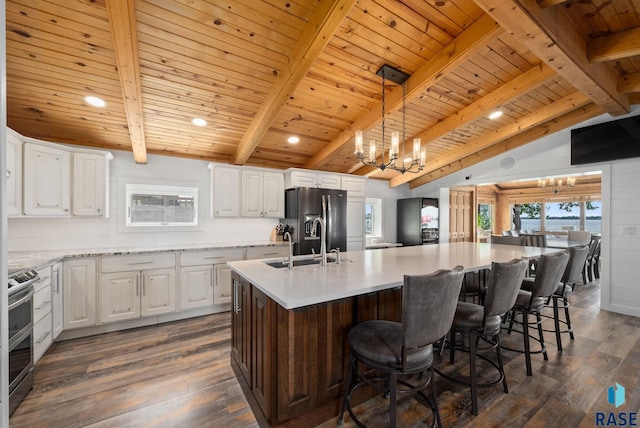 6604 Peninsula Pt, Wentworth, SD 57075 - kitchen featuring a sink, range with two ovens, refrigerator with ice dispenser, a chandelier, and dark wood-style flooring