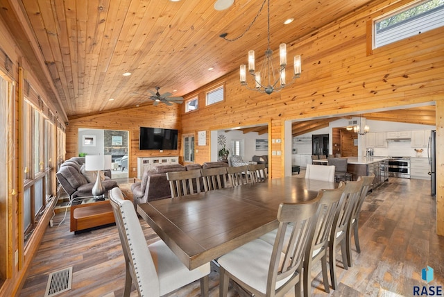 6604 Peninsula Pt, Wentworth, SD 57075 - dining space featuring wood walls, vaulted ceiling, a chandelier, dark wood-style floors, and wooden ceiling