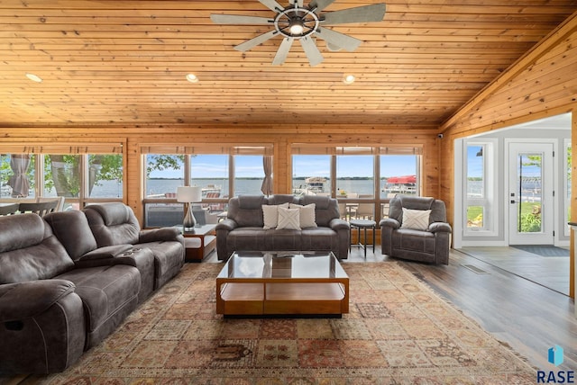 6604 Peninsula Pt, Wentworth, SD 57075 - living room with lofted ceiling, wood finished floors, a ceiling fan, wooden ceiling, and wooden walls