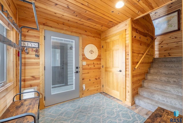 6604 Peninsula Pt, Wentworth, SD 57075 - entryway featuring wooden walls, stairs, wood finished floors, and wooden ceiling