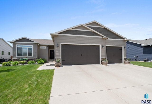 5205 S Eastwind Ave, Sioux Falls, SD 57108 - view of front of house with an attached garage, concrete driveway, and a front yard