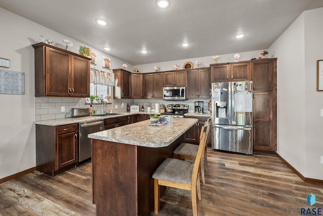 5205 S Eastwind Ave, Sioux Falls, SD 57108 - kitchen with stainless steel appliances, a sink, dark wood-style flooring, baseboards, and recessed lighting