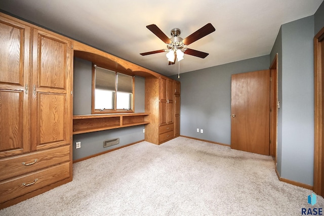 121 S Elm St, Lennox, SD 57039 - unfurnished bedroom with carpet flooring, baseboards, and a ceiling fan