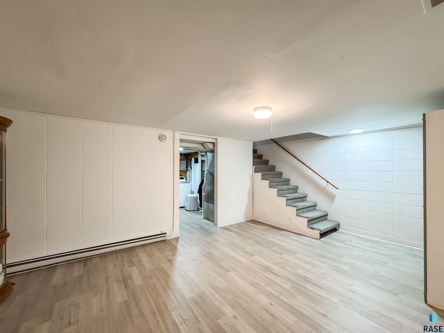 101 N Pipestone St Unit 3, Brandon, SD 57005 - finished below grade area featuring a baseboard heating unit, stairs, concrete block wall, light wood finished floors, and washer / dryer
