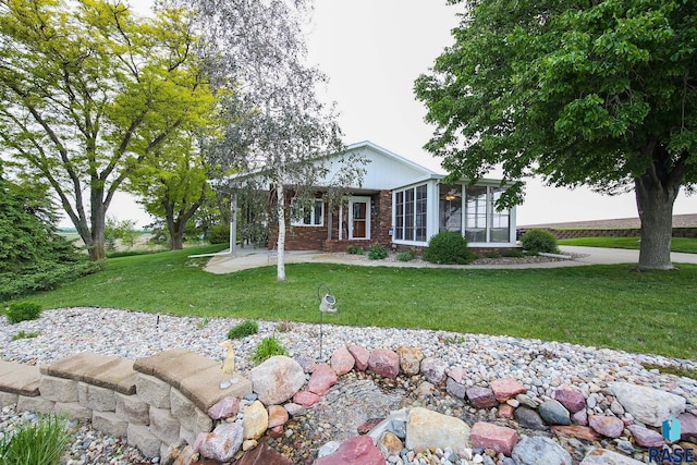 48224 266th St, Brandon, SD 57005 - ranch-style home with a front yard and a sunroom