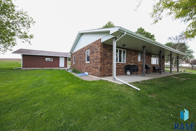48224 266th St, Brandon, SD 57005 - rear view of property featuring a yard, a patio area, and brick siding