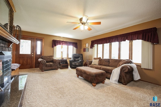 48224 266th St, Brandon, SD 57005 - carpeted living area featuring ceiling fan, plenty of natural light, a textured ceiling, and a fireplace