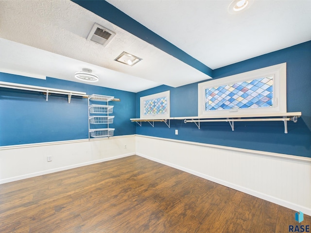 105 S Elm St, Lennox, SD 57039 - empty room with wood finished floors, a wainscoted wall, and baseboards