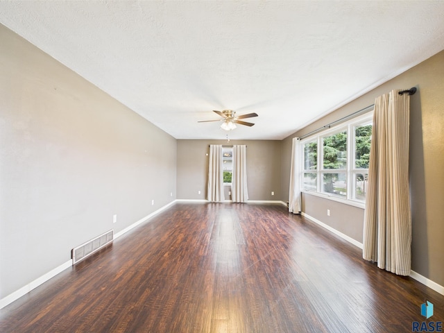 105 S Elm St, Lennox, SD 57039 - empty room with ceiling fan, wood finished floors, and healthy amount of natural light
