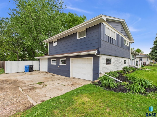 105 S Elm St, Lennox, SD 57039 - view of side of home with a garage, board and batten siding, concrete driveway, and stone siding