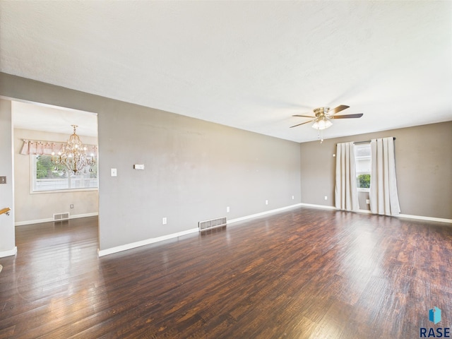 105 S Elm St, Lennox, SD 57039 - spare room with healthy amount of natural light, a ceiling fan, a chandelier, and wood finished floors