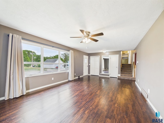 105 S Elm St, Lennox, SD 57039 - unfurnished living room with a ceiling fan, wood finished floors, baseboards, stairs, and a textured ceiling