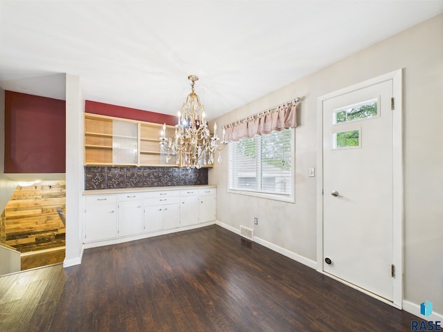 105 S Elm St, Lennox, SD 57039 - unfurnished dining area with dark wood-type flooring, a chandelier, and baseboards