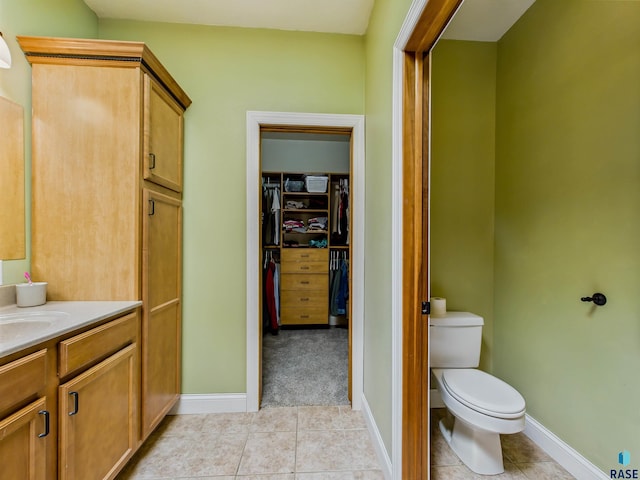 2601 N Devon Ave, Tea, SD 57064 - bathroom featuring vanity, tile patterned floors, toilet, a spacious closet, and baseboards