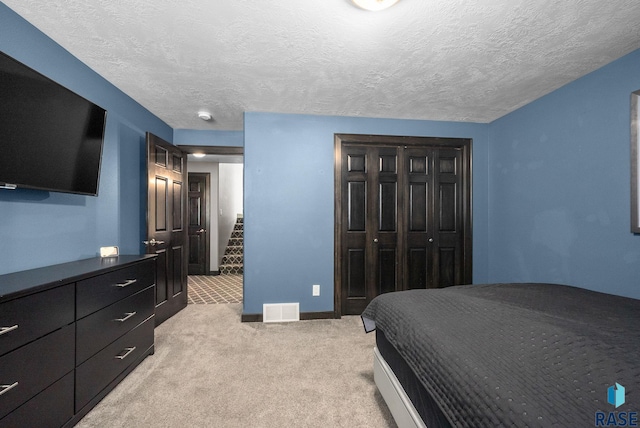 3909 E Shepherd St, Sioux Falls, SD 57103 - bedroom with light colored carpet, a closet, a textured ceiling, and baseboards