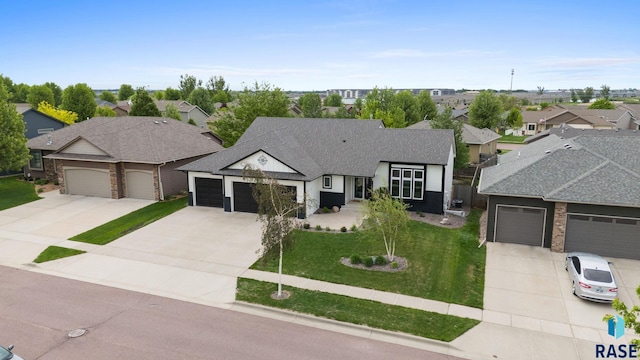 3909 E Shepherd St, Sioux Falls, SD 57103 - view of front of home with driveway, a residential view, an attached garage, and a shingled roof