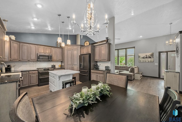3909 E Shepherd St, Sioux Falls, SD 57103 - kitchen featuring stainless steel appliances, light wood-style floors, a chandelier, a kitchen island, and lofted ceiling