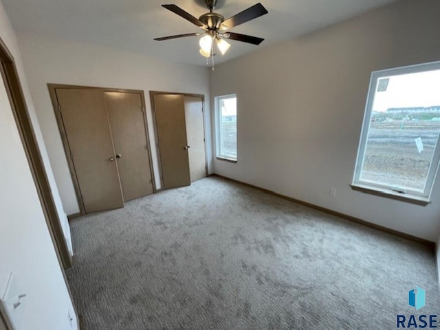 3408 S Heather Ave, Sioux Falls, SD 57106 - unfurnished bedroom featuring carpet, multiple closets, and ceiling fan