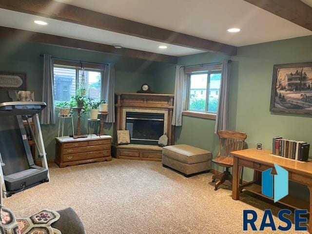 218 S Douglas St, Inwood, IA 51240 - living area featuring beamed ceiling, carpet, a glass covered fireplace, recessed lighting, and baseboards