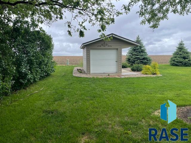 218 S Douglas St, Inwood, IA 51240 - view of green lawn with an outbuilding