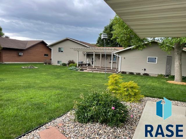 218 S Douglas St, Inwood, IA 51240 - view of grassy yard with a pergola