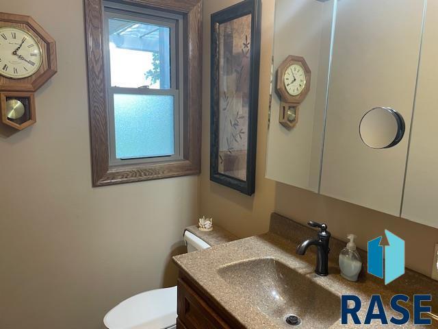 218 S Douglas St, Inwood, IA 51240 - half bath featuring toilet and vanity