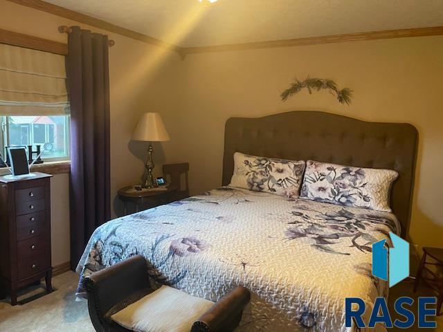 218 S Douglas St, Inwood, IA 51240 - carpeted bedroom with crown molding