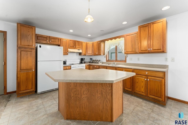 39240 210th St, Huron, SD 57350 - kitchen with white appliances, under cabinet range hood, a sink, recessed lighting, and light countertops