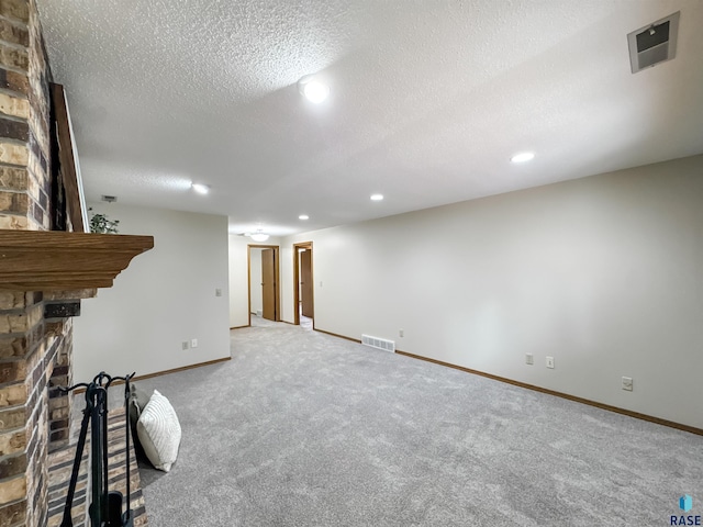 2405 E 51st St, Sioux Falls, SD 57103 - unfurnished living room with a large fireplace, carpet, recessed lighting, baseboards, and a textured ceiling
