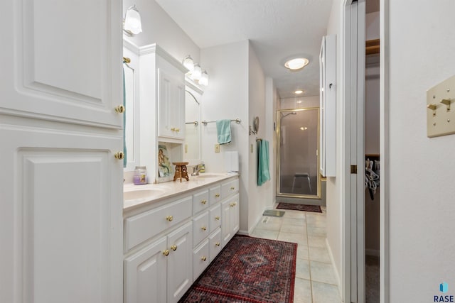 7005 W Strabane Trl, Sioux Falls, SD 57106 - full bathroom featuring tile patterned floors, a stall shower, double vanity, and baseboards