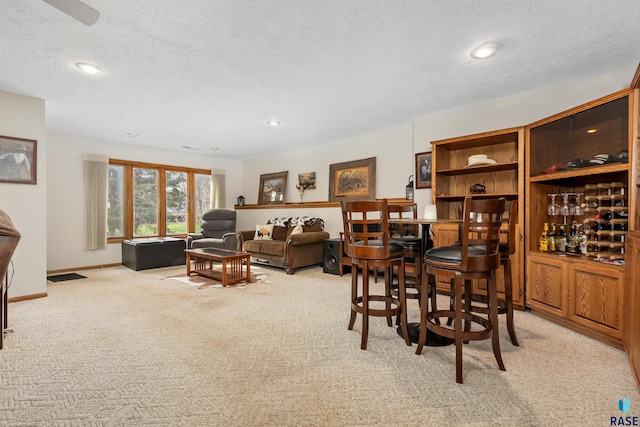 7005 W Strabane Trl, Sioux Falls, SD 57106 - dining area featuring light colored carpet, a textured ceiling, recessed lighting, a bar, and baseboards