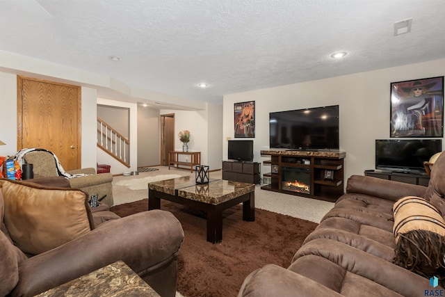 7005 W Strabane Trl, Sioux Falls, SD 57106 - carpeted living area with stairway, a glass covered fireplace, and recessed lighting