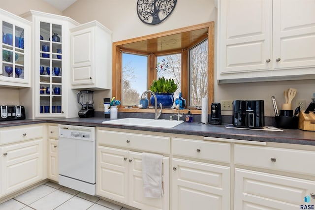 7005 W Strabane Trl, Sioux Falls, SD 57106 - kitchen featuring white dishwasher, a sink, dark countertops, and light tile patterned floors