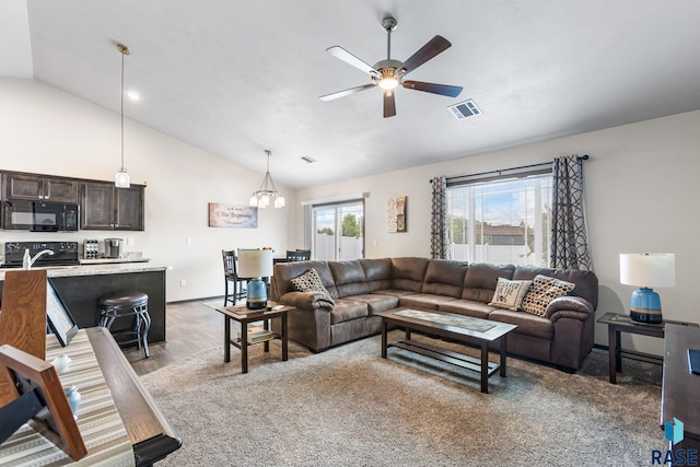 6702 W Gresford Pl, Sioux Falls, SD 57106 - living room with vaulted ceiling, a ceiling fan, light wood-style flooring, a chandelier, and baseboards