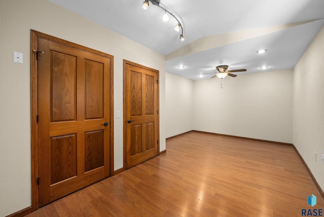 912 N Minnesota Ave, Sioux Falls, SD 57104 - empty room featuring a ceiling fan, light wood-style floors, vaulted ceiling, and baseboards