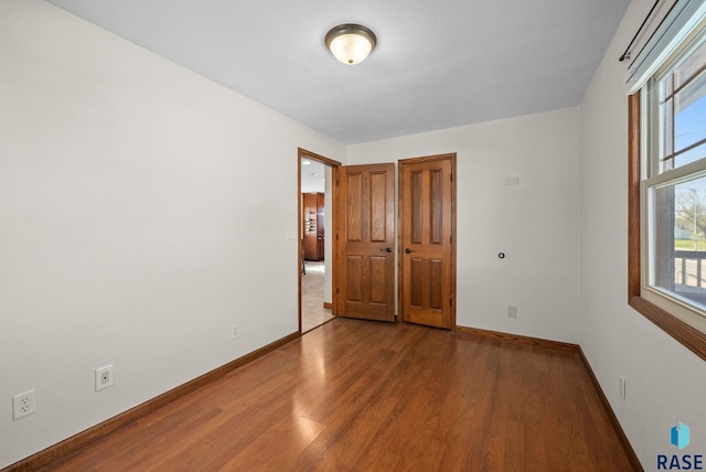912 N Minnesota Ave, Sioux Falls, SD 57104 - unfurnished room featuring wood finished floors, baseboards, and healthy amount of natural light