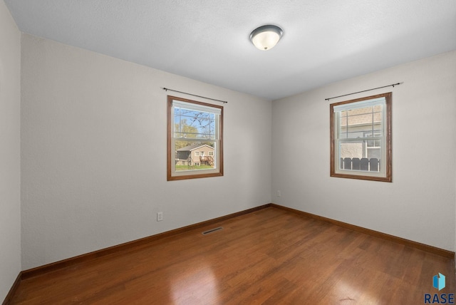 912 N Minnesota Ave, Sioux Falls, SD 57104 - spare room featuring wood finished floors and baseboards