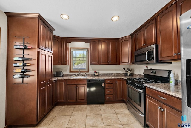 912 N Minnesota Ave, Sioux Falls, SD 57104 - kitchen with appliances with stainless steel finishes, a sink, light tile patterned floors, and recessed lighting