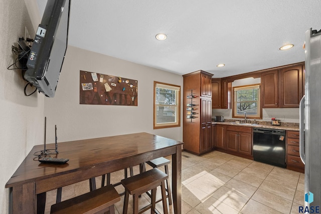 912 N Minnesota Ave, Sioux Falls, SD 57104 - kitchen featuring black dishwasher, healthy amount of natural light, recessed lighting, freestanding refrigerator, and light tile patterned floors