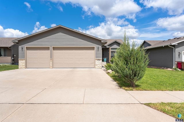 1716 E Tracy Ln, Sioux Falls, SD 57103 - single story home featuring stone siding, concrete driveway, a garage, and a front yard