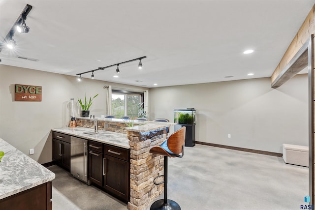 1716 E Tracy Ln, Sioux Falls, SD 57103 - kitchen featuring rail lighting, finished concrete flooring, and high end fridge