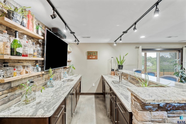 1716 E Tracy Ln, Sioux Falls, SD 57103 - kitchen with track lighting, open shelves, a sink, and baseboards