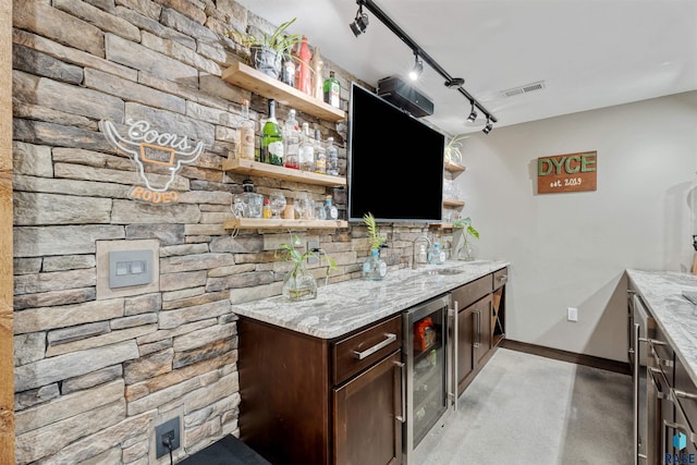 1716 E Tracy Ln, Sioux Falls, SD 57103 - indoor wet bar featuring beverage cooler, baseboards, finished concrete flooring, and rail lighting