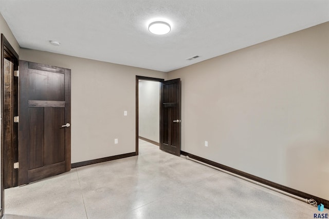 1716 E Tracy Ln, Sioux Falls, SD 57103 - unfurnished bedroom with baseboards and finished concrete flooring