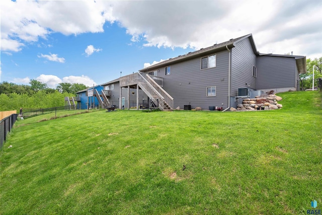 1716 E Tracy Ln, Sioux Falls, SD 57103 - back of property featuring stairs, a wooden deck, and central AC