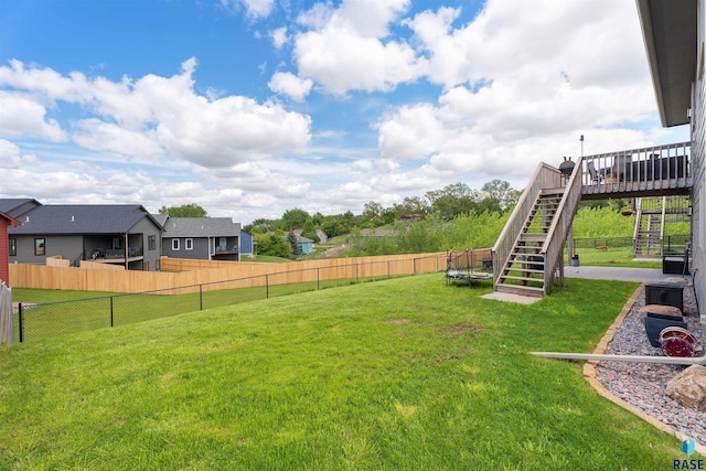 1716 E Tracy Ln, Sioux Falls, SD 57103 - view of yard featuring stairs, a wooden deck, and a trampoline